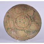 A PERSIAN POTTERY SHALLOW BOWL, decorated internally with a symbols. 26.5 cm wide.