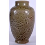 A CHINESE GREEN GLAZED POTTERY VASE, incised with foliage. 17 cm high.