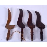 FOUR ANTIQUE WOODEN INSTRUMENTS, varying age, possibly training knives. Longest 27 cm. (4)