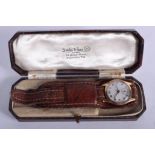 A BOXED ANTIQUE 9CT GOLD WRISTWATCH. 2.75 cm wide.