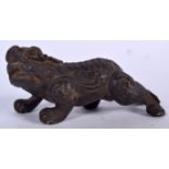 A CHINESE BRONZE FIGURE OF A MYTHICAL BEAST, formed prowling. 12 cm wide.