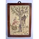 A 19TH CENTURY CONTINENTAL CARVED AND PAINTED IVORY PLAQUE depicting a boy and girl picking fruit.