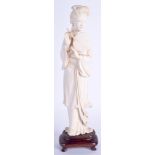 AN EARLY 20TH CENTURY CHINESE CARVED IVORY FIGURE modelled holding a fan. 23 cm high.