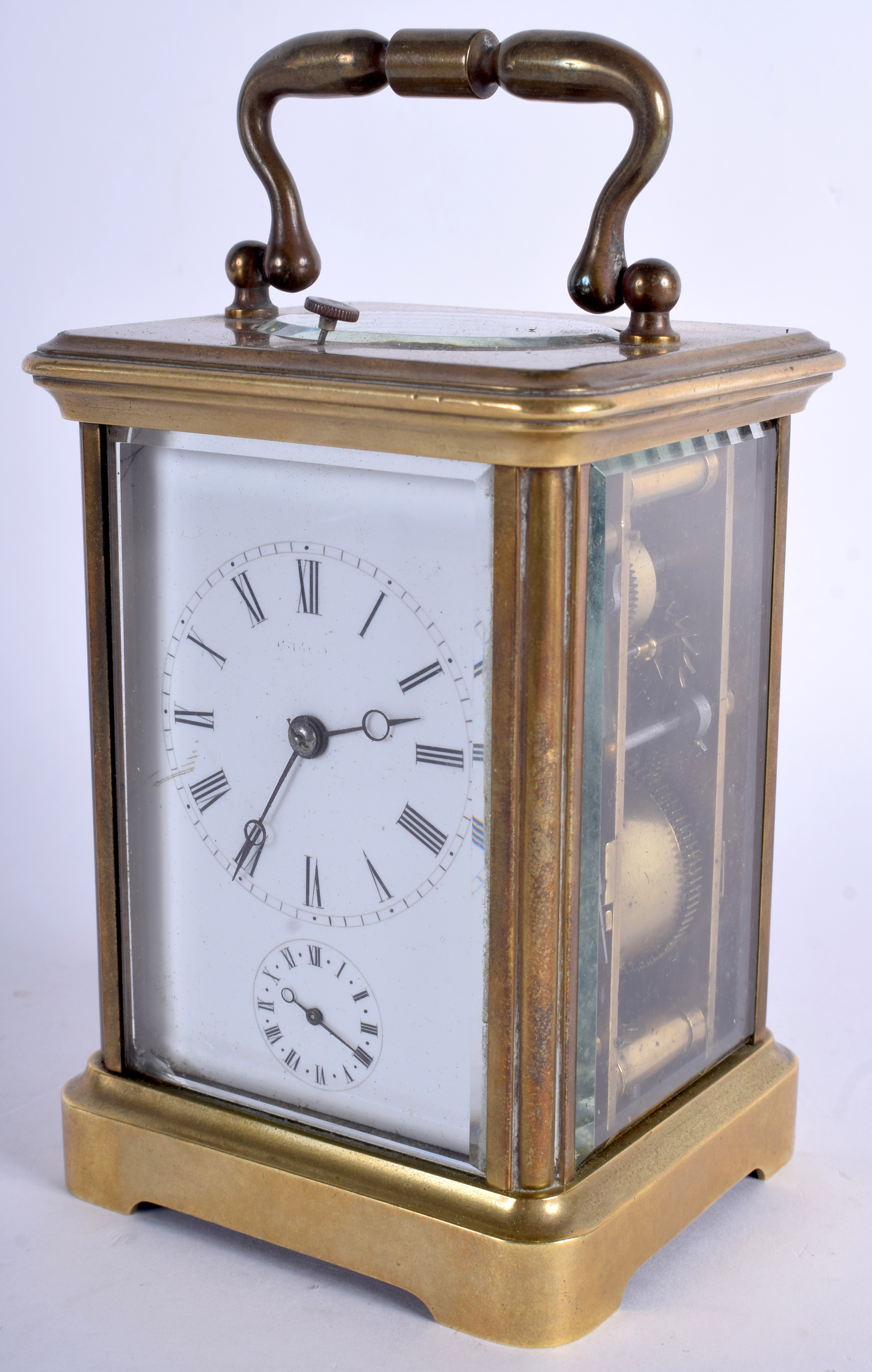 AN ANTIQUE REPEATING BRASS CARRIAGE CLOCK with white enamel dial. 15 cm high inc handle.