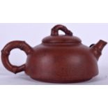 A CHINESE YIXING OR ZISHA POTTERY TEA POT, signed. 15 cm wide.