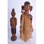 TWO EARLY 20TH CENTURY AFRICAN TRIBAL HARDWOOD FIGURES one wearing cloth clothing. 25 cm & 19 cm hi