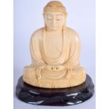 A 19TH CENTURY JAPANESE MEIJI PERIOD CARVED IVORY OKIMONO modelled as a seated buddha. 9.5 cm high.