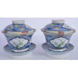 A PAIR OF CHINESE FAMILLE ROSE BLUE AND WHITE BOWLS AND COVERS with matching stands, possibly Guang