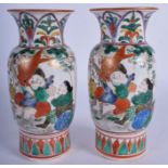 A PAIR OF 19TH CENTURY JAPANESE MEIJI PERIOD KUTANI VASES painted with figures. 19 cm high.