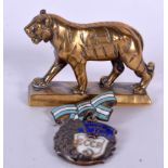 A BRASS FIGURE OF A STANDING TIGER, together with a Russian medal. (2)