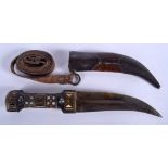 A 19TH CENTURY MIDDLE EASTERN CARVED HORN AND IVORY HANDLED DAGGER with steel and leather scabbard.