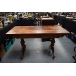 A 19TH CENTURY ROSEWOOD SOFA TABLE, formed with two short drawers on each side and curved legs. 73