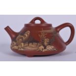 A CHINESE YIXING OR ZISHA POTTERY TEA POT, overlaid with landscape scenery, signed. 12.5 cm wide.