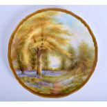 A ROYAL WORCESTER PLATE painted with Blue Bells Kew Garden, titled verso, by Raymond Rushton, signe
