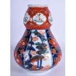 A 19TH CENTURY JAPANESE MEIJI PERIOD IMARI VASE painted with landscapes. 20 cm high.