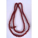 A LONG STRAND CHINESE AGATE BEAD NECKLACE, carved with geometric symbols. 142 cm long.