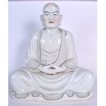 A VERY LARGE 1950S CHINESE PORCELAIN FIGURE OF A BUDDHA modelled with clasped hands and highlighted