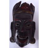 A BALINESE WOODEN MASK OF A LASCIVIOUS MALE, polychromed remnants. 26 cm long.