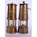 A MATCHED PAIR OF VINTAGE BRASS MINER LAMPS, one decorated with the crest of a mythical beast. 25