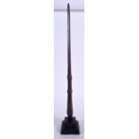 AN EARLY ISLAMIC BRONZE SPEAR TIP, fitted upon a stand. 61 cm high.