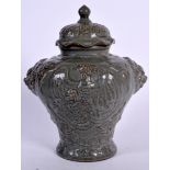 A CHINESE GREEN GLAZED POTTERY BALUSTER VASE AND COVER, formed with mask head handles and decorated