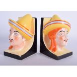 A PAIR OF CONTINENTAL ART DECO BOOK ENDS depicting a male and female. 15 cm x 7 cm.