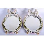 A PAIR OF ANTIQUE GERMAN PORCELAIN ENCRUSTED MIRRORS. 26 cm x 34 cm.