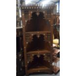 MANNER OF LIBERTY'S WOODEN CORNER SHELVING UNIT, carved with extensive foliage and inset with mothe