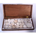 A COLLECTION OF ANTIQUE PLASTER INTAGLIOS, contained within a wooden box. Box 33.5 cm wide.