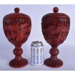 A RARE PAIR OF 19TH CENTURY CHINESE CINNABAR LACQUER VASES AND COVERS Qing, carved with scholars wi