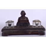 A BRONZE DESK STAND FORMED WITH A WILLIAM SHAKESPEARE BUST, with original glass ink pots. 27 cm wid
