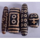 FOUR EARLY 20TH CENTURY CHINESE TIBETAN ZHU BEADS. Largest 6 cm long. (4)