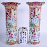 A LARGE PAIR OF 19TH CENTURY CHINESE CANTON FAMILLE ROSE VASES painted with figures. 29 cm high.