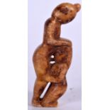 A CARVED STONE EROTIC FIGURE, formed as a busty female inspecting her friends genitals. 8 cm high.