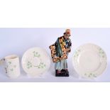 A ROYAL DOULTON FIGURE OF THE CARPET SELLER together with a Belleek trio. (4)