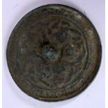 A CHINESE BRONZE HAND MIRROR, decorated in relief with foliage. 10.5 cm wide.
