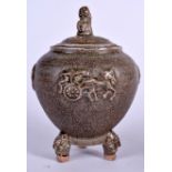 A CHINESE TRI LEGGED GREEN GLAZED POTTERY CENSER, the finial in the form of a foo dog. 23 cm high.