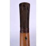 AN EARLY 20TH CENTURY RHINOCEROS HORN HANDLED WALKING CANE, formed with a ribbed terminal. 90 cm lo