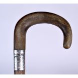 AN EARLY 20TH CENTURY RHINOCEROS HORN HANDLED WALKING STICK, formed with a silver Birmingham hallma