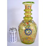A LARGE ANTIQUE BOHEMIAN GREEN GLASS DECANTER enamelled with foliage. 32 cm high.