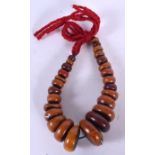 A TIBETAN MALA BEAD NECKLACE, formed with flattened beads. 38 cm long.