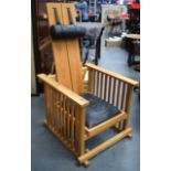 AN UNUSUAL 1980'S OAK CHAIR, formed with a leather head rest and seat. 125 cm x 65.5 cm.