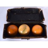 AN ANTIQUE IVORY SNOOKER BALL, together with two other balls, in original case. Case 18 cm wide.