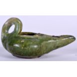 A PERSIAN GREEN GLAZED POTTERY OIL LAMP, formed with a looping handle. 12 cm wide.