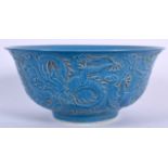 A CHINESE BLUE GLAZED PORCELAIN BOWL BEARING QIANLONG MARKS, decorated with dragons in pursuit of t