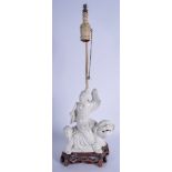 A 19TH CENTURY CHINESE BLANC DE CHINE FIGURE OF A BUDDHA modelled upon a lion, converted to a lamp.