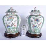 A PAIR OF 19TH CENTURY CHINESE FAMILLE VERTE VASES AND COVERS Kangxi style, painted with foliage an