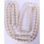 A CHINESE WHITE HARDSTONE NECKLACE, formed with flattened spherical beads. 150 cm long.