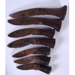 A GROUP OF SEVEN SMALL NEPALESE KUKRI BLADES, formed with wooden handles. Largest 14 cm. (7)