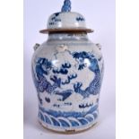 A LARGE CHINESE BLUE AND WHITE PORCELAIN TEMPLE JAR AND COVER, painted with dragons in pursuit of t